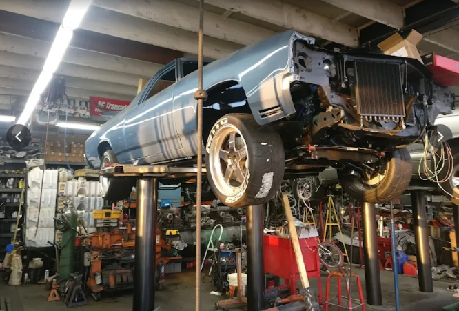 Car on lift being repaired